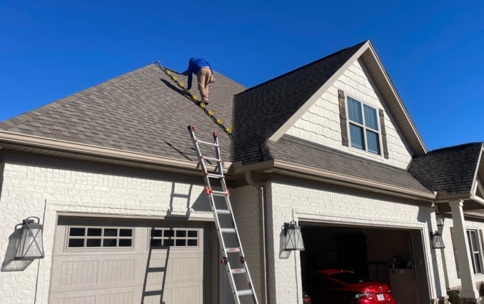 Home inspector climbing on the roof