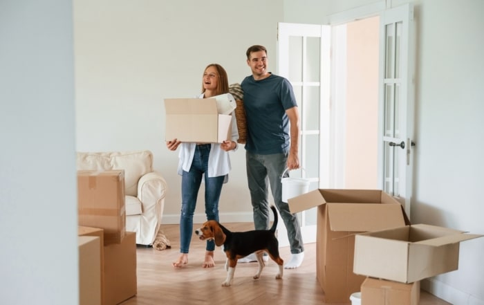 Couple packing up moving boxes as they prepare to sell