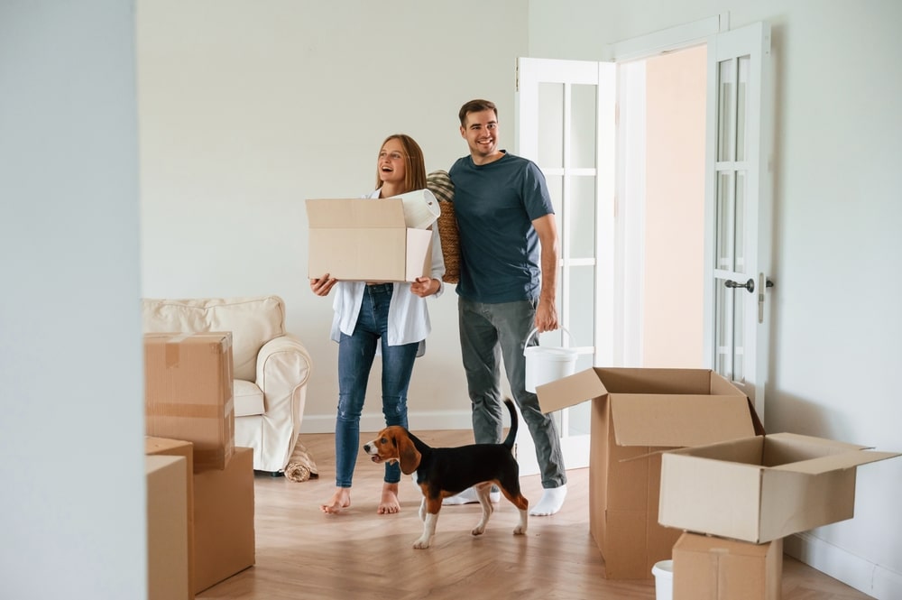 Couple packing up moving boxes as they prepare to sell