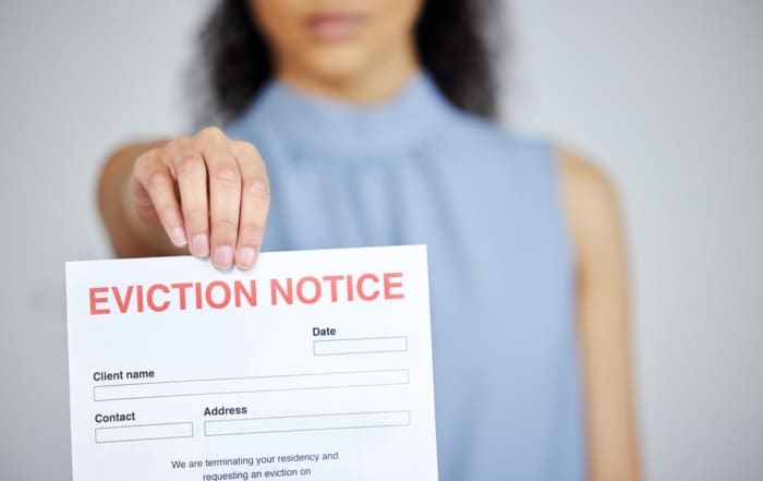 Woman holding up a piece of paper that says 