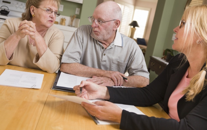 Couple getting counseled on their mortgage refinance