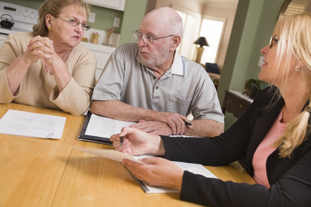 Couple getting counseled on their mortgage refinance