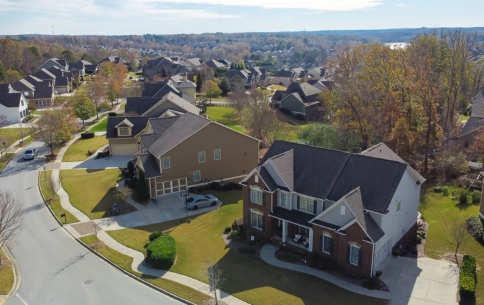 Aerial view of a Suburban Residential Street With Row Of Upscale Two-story houses