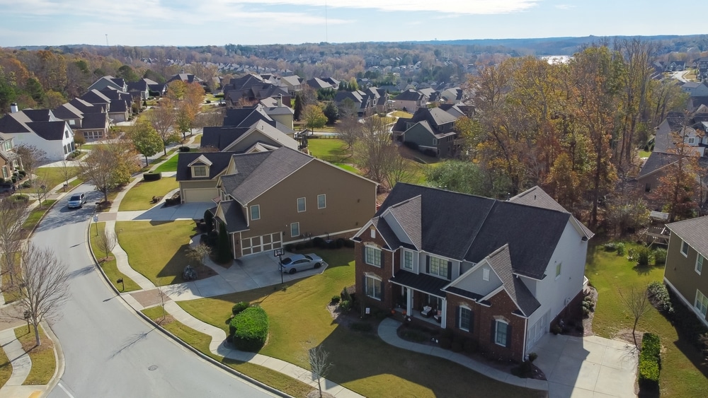 Aerial view of a Suburban Residential Street With Row Of Upscale Two-story houses